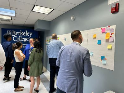 Group of Berkeley College CDS participants engaged in a workflow mapping exercise using sticky notes.